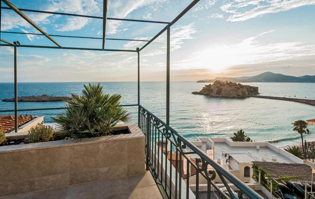 a view of the ocean from the balcony of a house at Hotel Azimut in Sveti Stefan