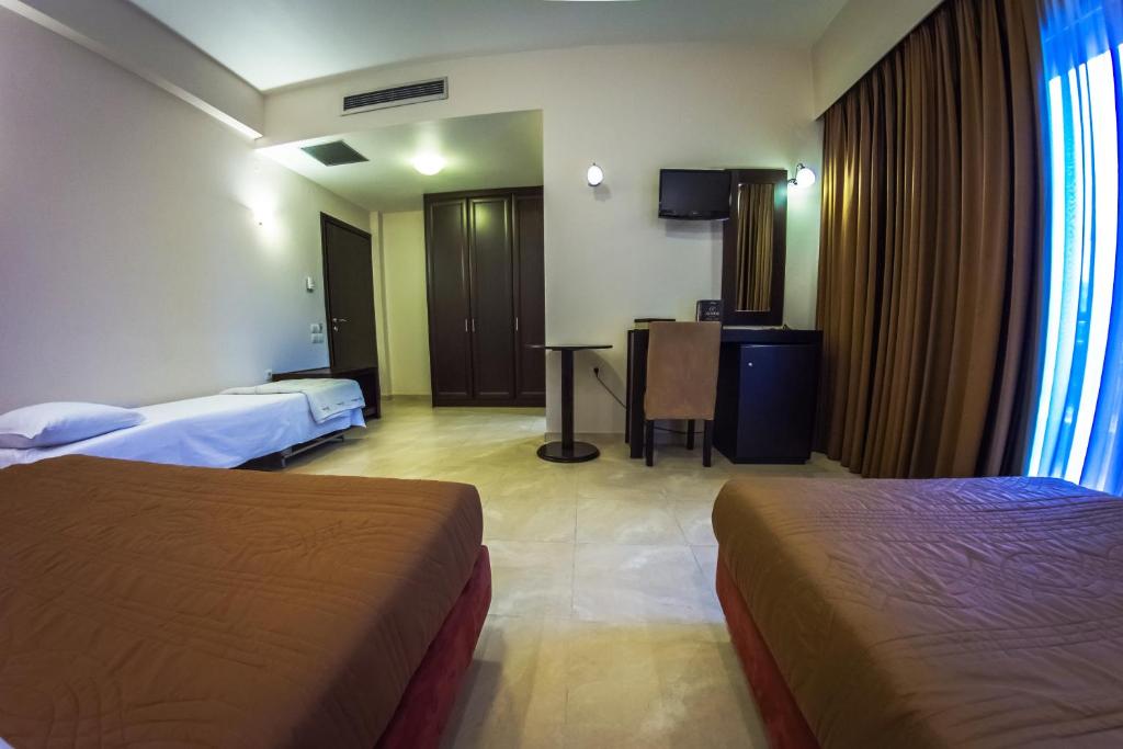 Postel nebo postele na pokoji v ubytování Giotis Boutique Hotel