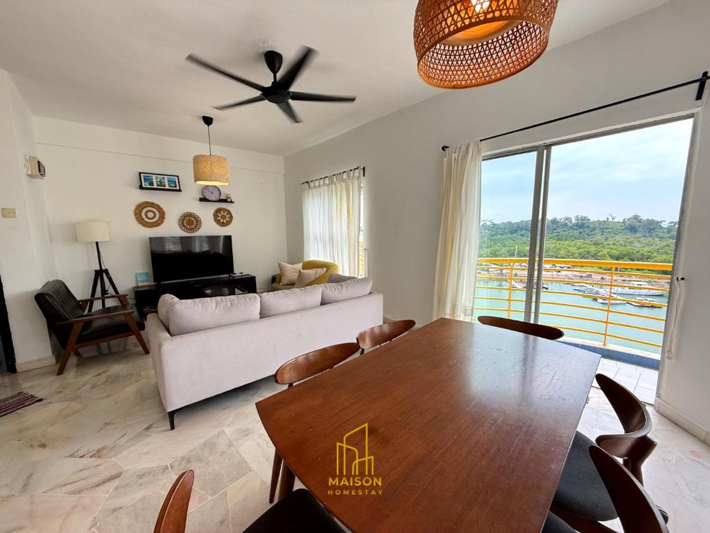 a living room with a table and a couch at BayView Suites Port Dickson By MAISON in Port Dickson