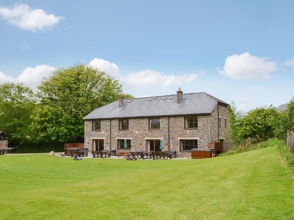 a large stone house with a large grassy yard at Elderberry House in Kelly