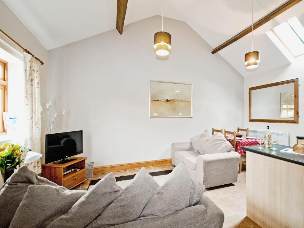 a living room with a couch and a tv at Hirst House - W41947 in Filey