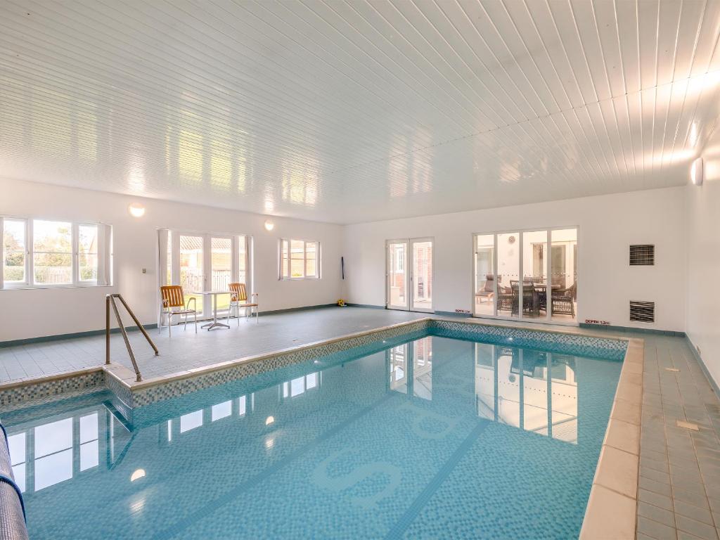 a swimming pool in a house with a ceiling at The Willows in Sea Palling