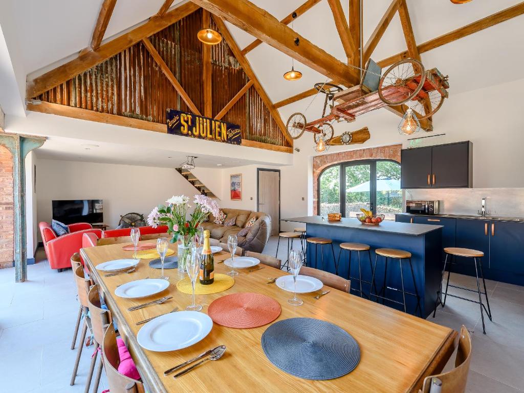 a dining room and kitchen with a wooden table and chairs at Go Cart Barn in Gloucester