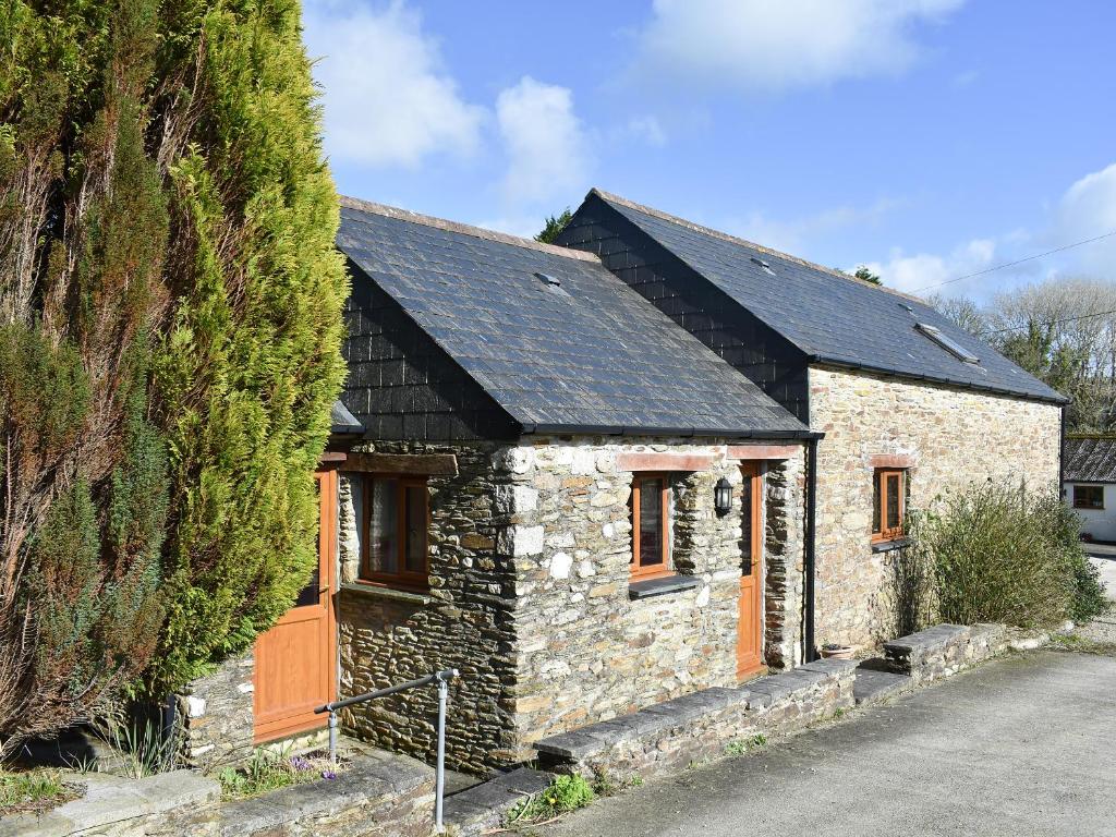 a small stone house with a black roof at Ricann - Ukc4244 in Lanreath