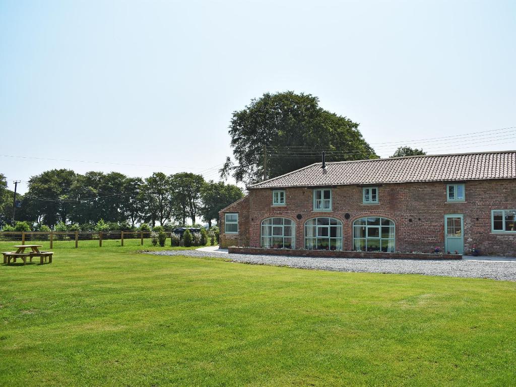a brick building with a picnic table in front of it at The Granary Uk13197 in Butterwick
