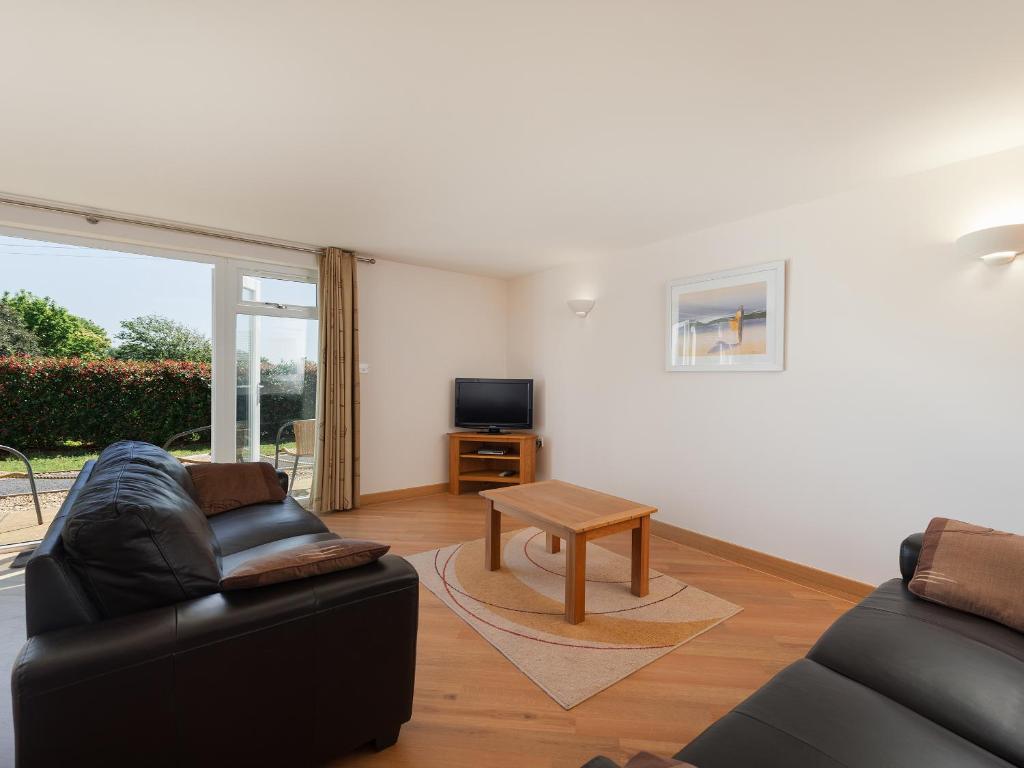 a living room with a couch and a table at 2 Red Rock Apartments in Dawlish Warren