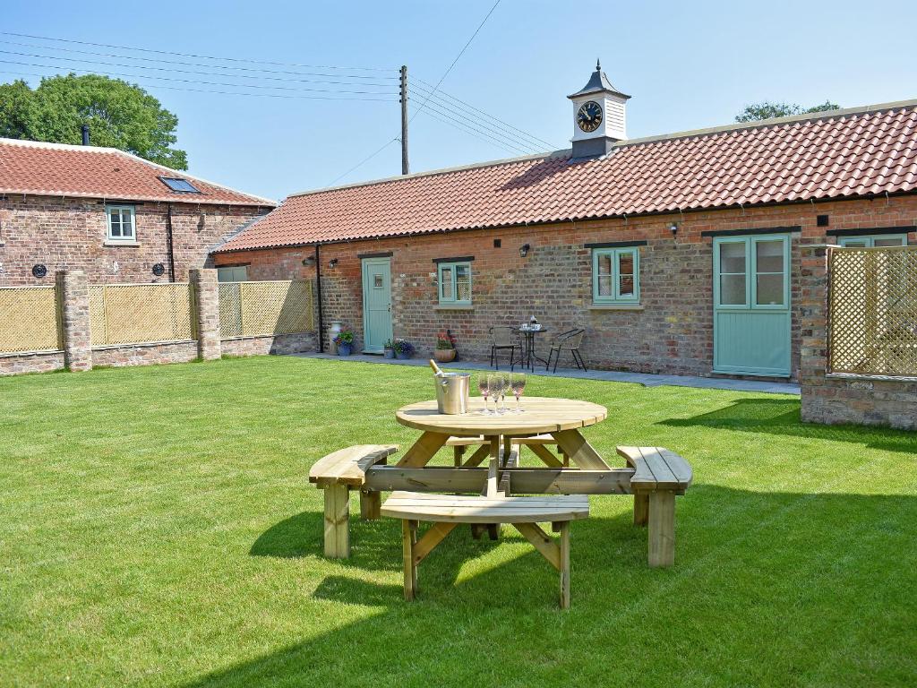 a picnic table and bench in a yard at The Dairy Uk13198 in Butterwick