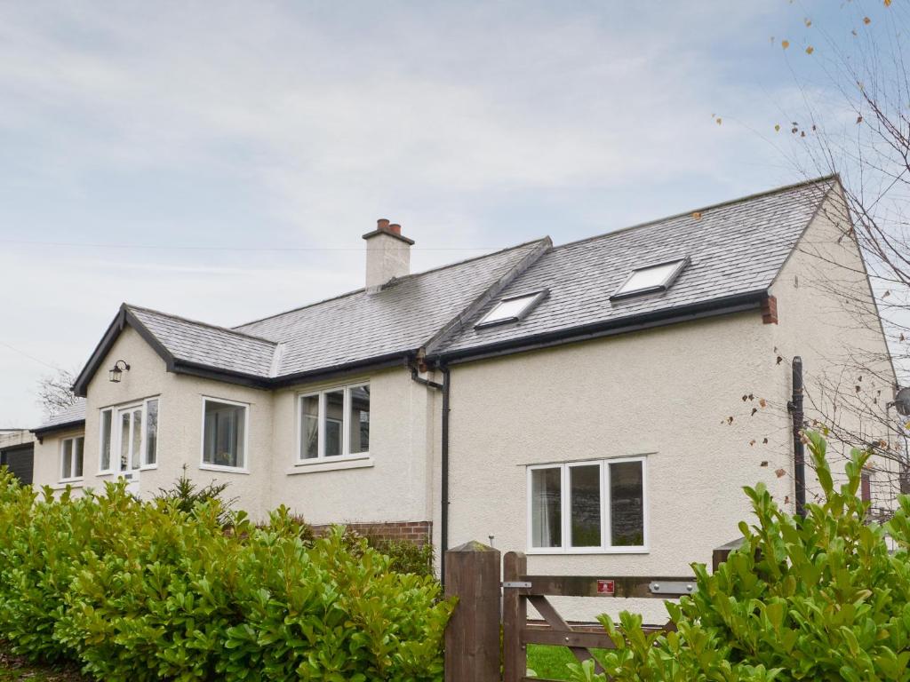a white house with a black roof at Heatherlea in Otterburn