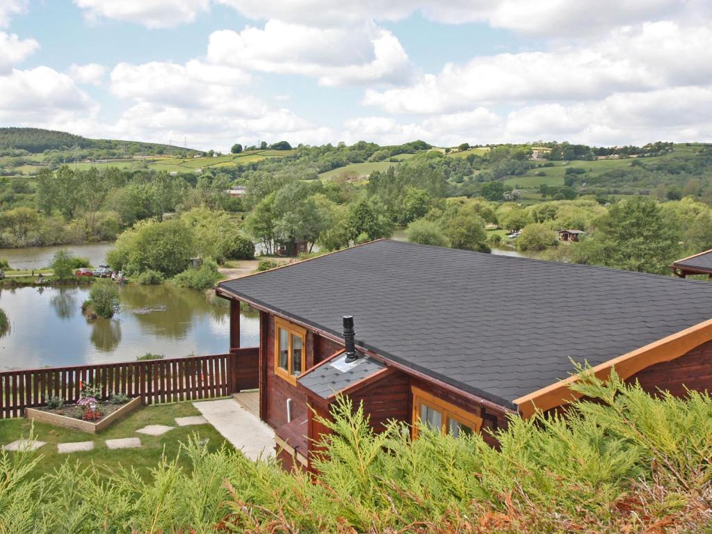 an aerial view of a house with a lake at White Springs - Lake View in Llanedy