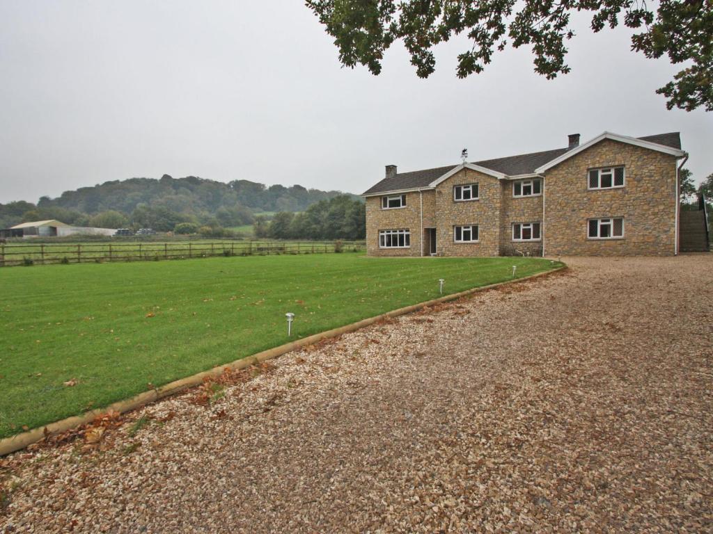 a large brick house with a field in front of it at Springfield Court - Lakeview in Bonvilston