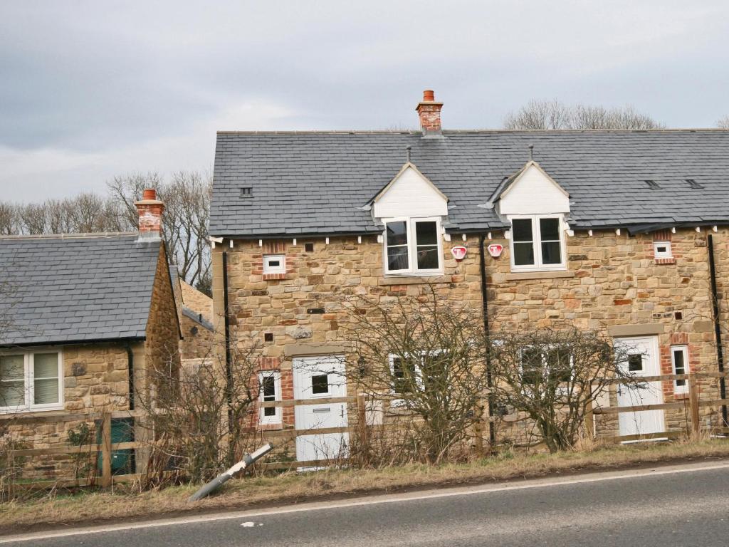an old stone house on the side of the road at New Bakery in Glanton