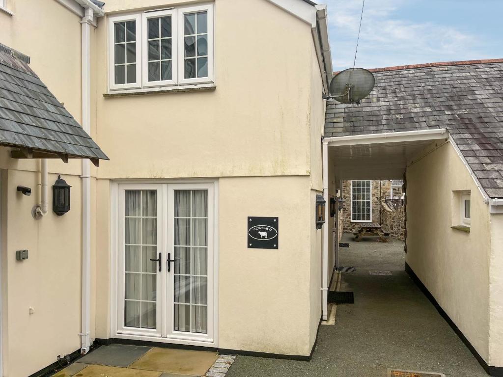 an entrance to a house with a garage at Cowshed - Uk49024 in Liskeard
