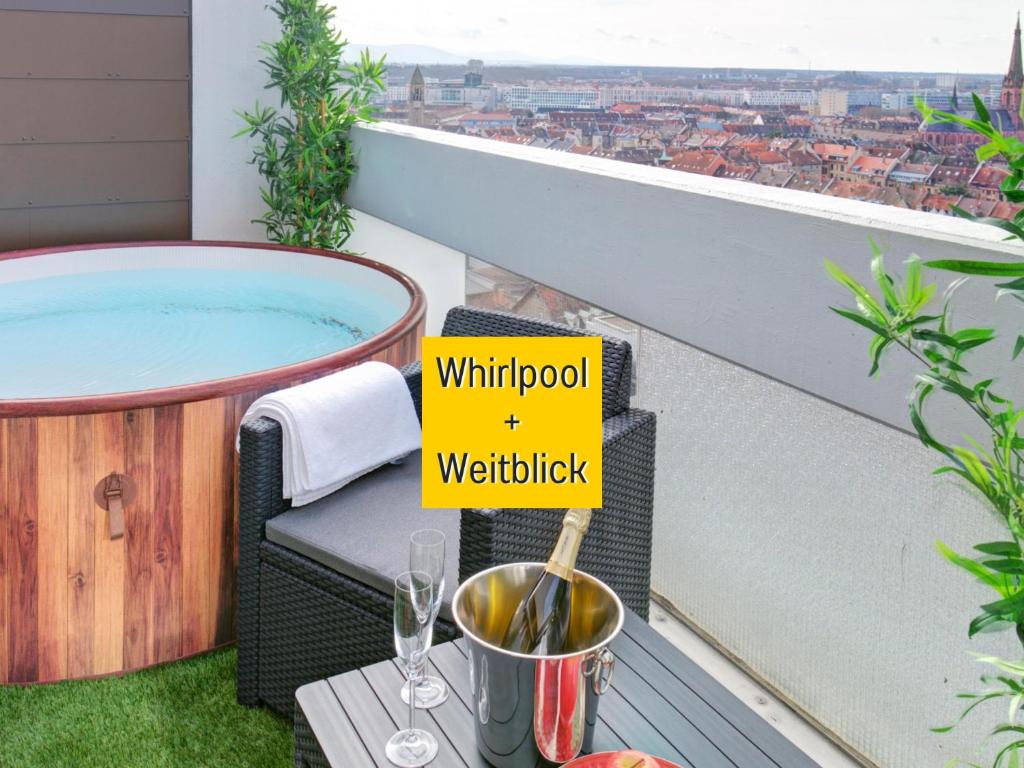 a hot tub on a balcony with a sign that reads window waterfall at Das Penthouse mit 3 Dachterrassen, Whirlpool & Panoramablick in Karlsruhe