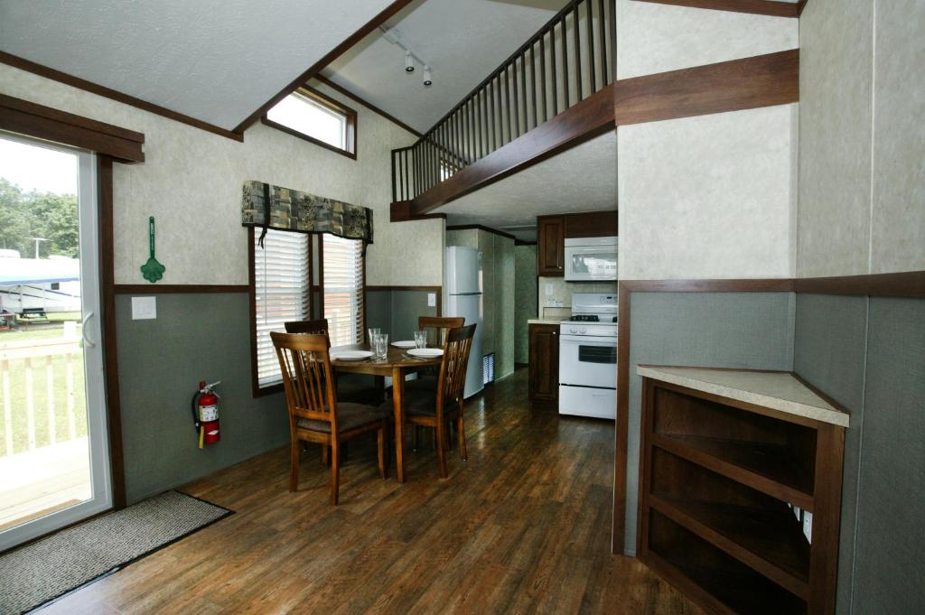 a kitchen and dining room with a table and chairs at Arrowhead Camping Resort Cottage 11 in Douglas Center