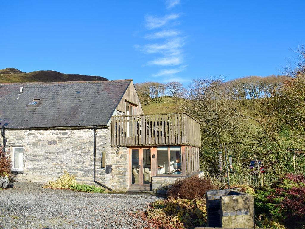 a stone house with a deck on top of it at Penroc in Pentre-briwnant