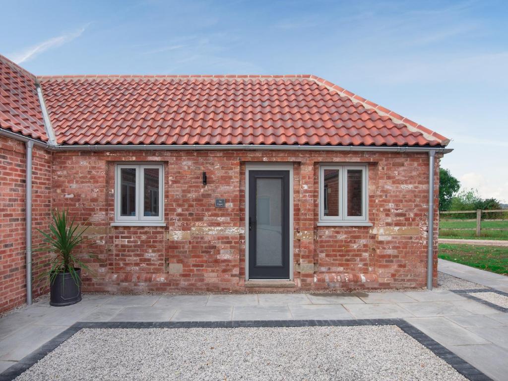 a brick house with a red roof at The Piggery - Uk37348 in Hockerton