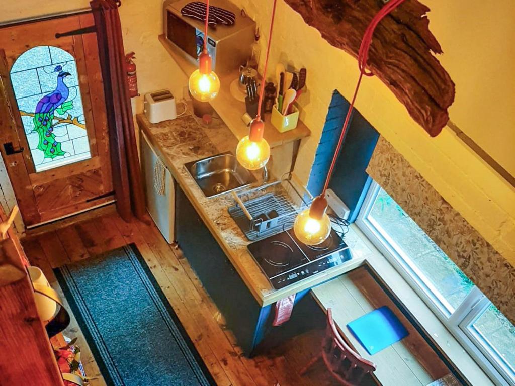 an overhead view of a small kitchen with a stove at Y Smithy - Uk49022 in Llanybyther