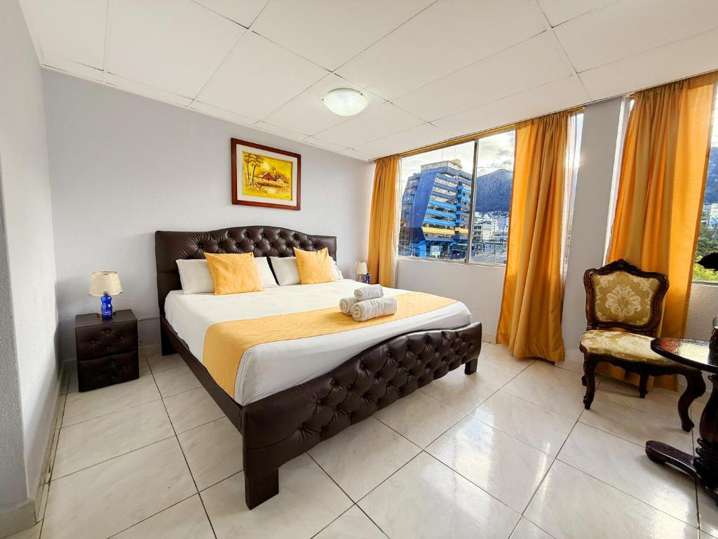 a bedroom with a large bed and a window at Hotel Santamaria en quito in Quito