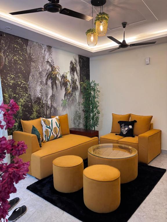 a living room with yellow couches and a coffee table at Whispering Vines by Blessings in Rishīkesh