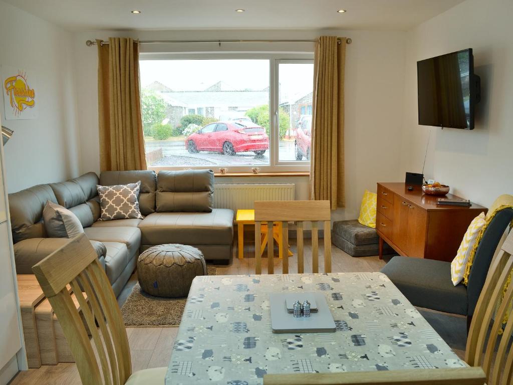 a living room with a couch and a table at Lle Clyd in Harlech