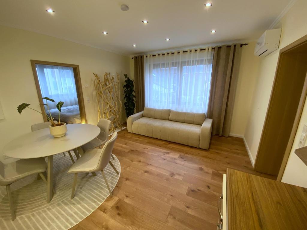 a living room with a table and a couch at Cozy apartment in Irrel in Irrel