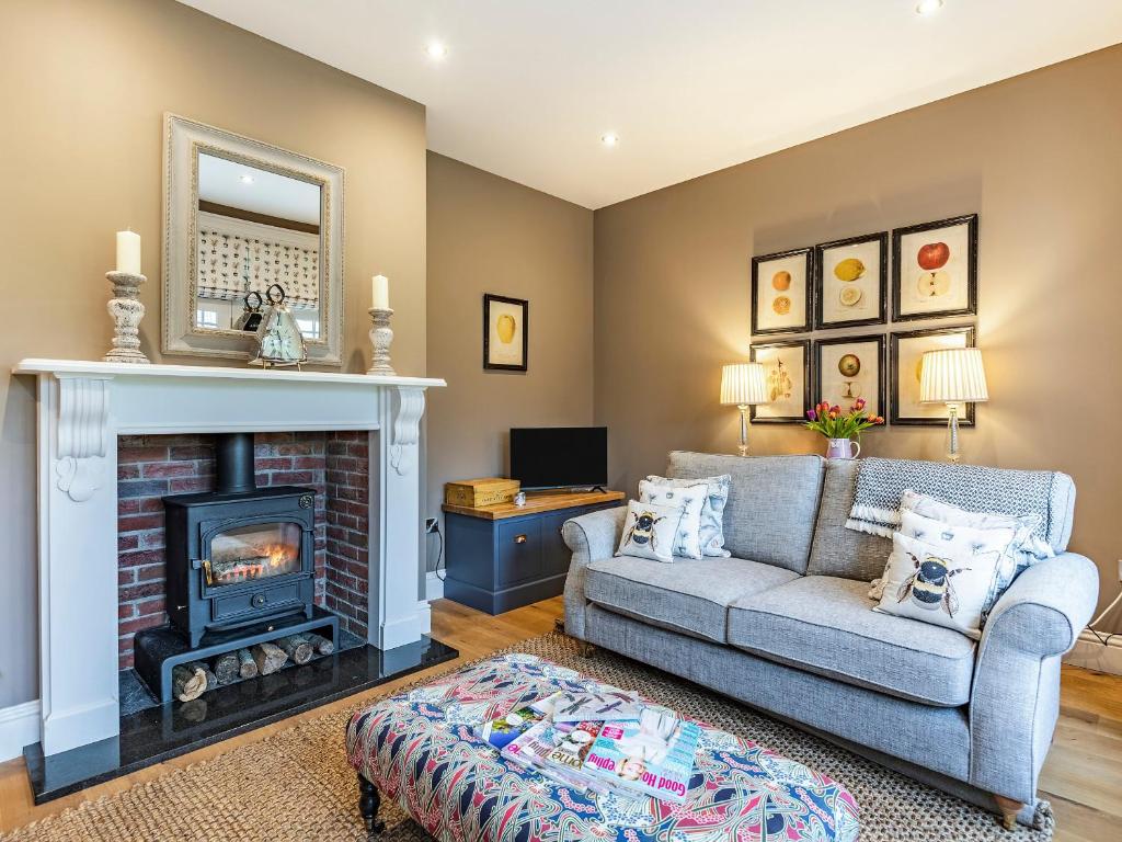 a living room with a couch and a fireplace at The Pavilion in Willoughby