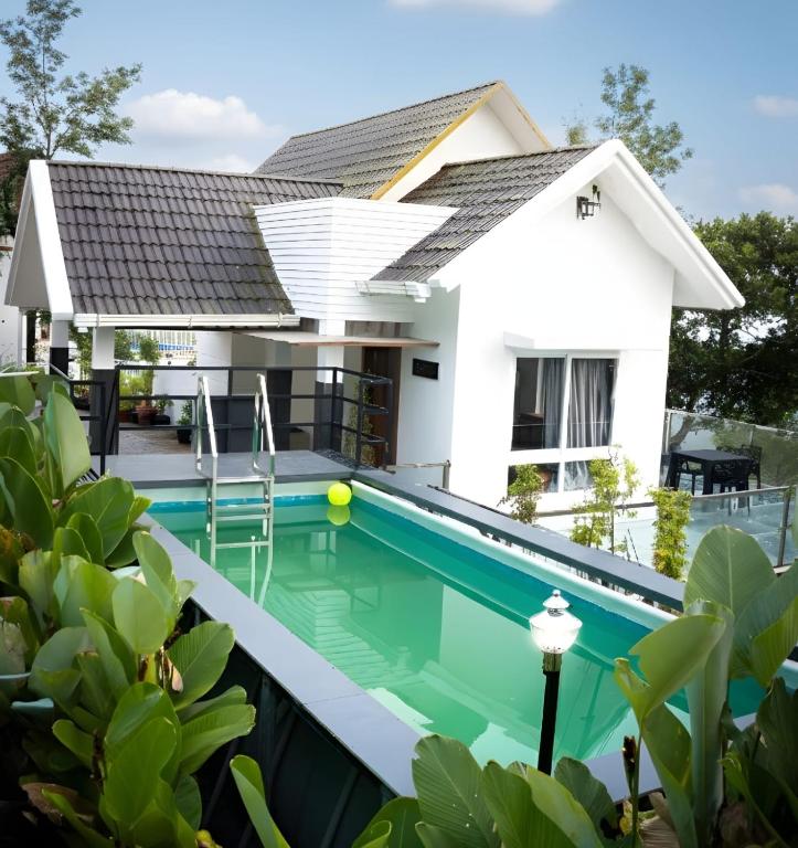 a house with a swimming pool in front of it at moonlight palace private pool villa vagamon in Vagamon