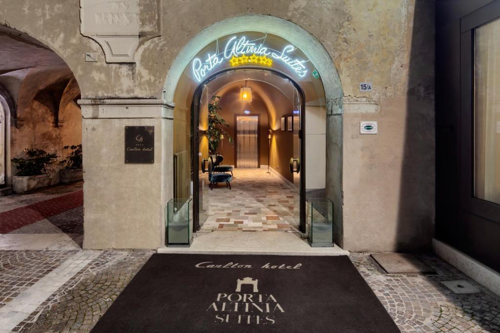 an entrance to a building with a sign on the floor at Porta Altinia Suites in Treviso