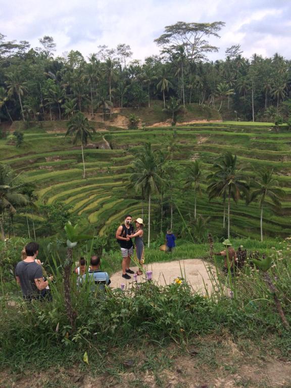 a group of people standing in front of a field at Pangkung House in Ubud