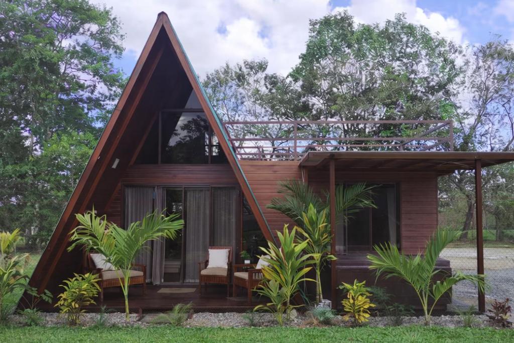 a small house with a pitched roof at Sol y Luna Chalet with volcano view and Jacuzzi in Fortuna