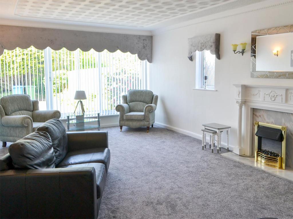 a living room with a couch and a fireplace at Dunpullin in Bedlington