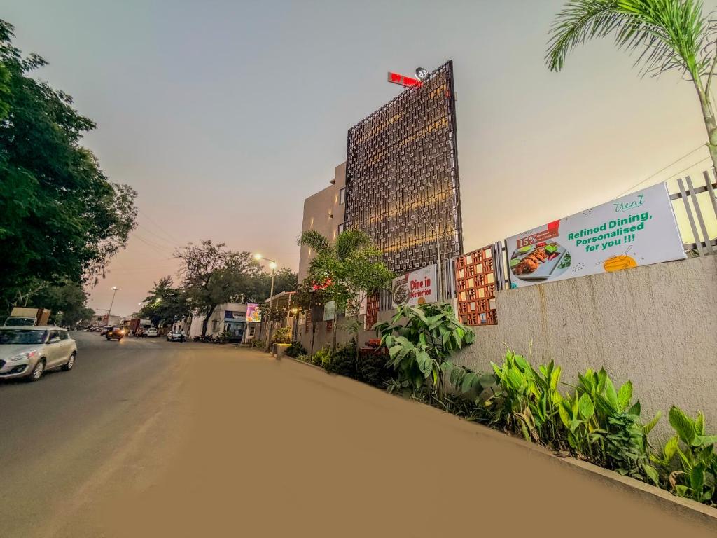 a street with a building on the side of a road at Zip By Spree Hotels Chinchwad in Chinchwad