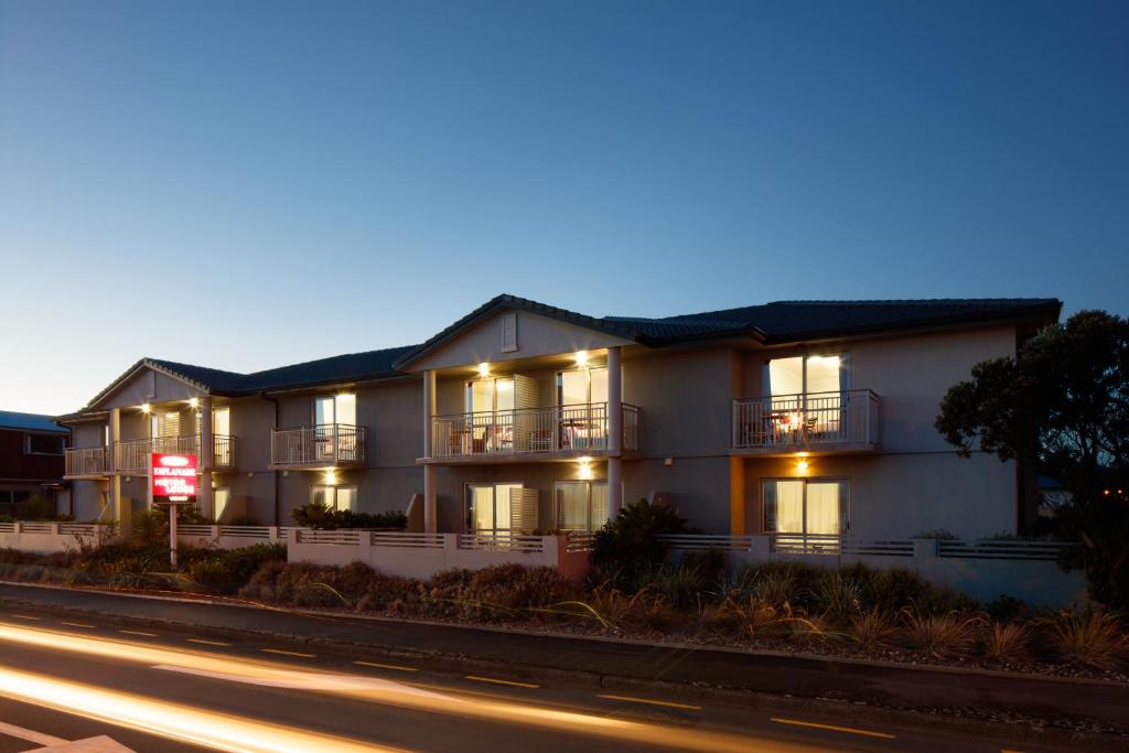 a building with lights on the side of a street at BKs Premier Motel Esplanade in Lower Hutt