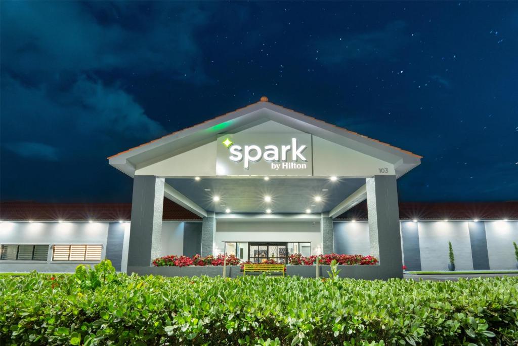 a building with a sign that reads spark insurance at Spark by Hilton Ponce in Ponce