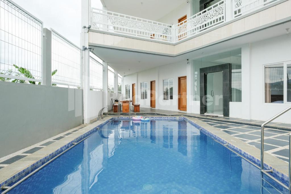 a swimming pool with blue water in a building at Sazara Hotel Batu in Selecta