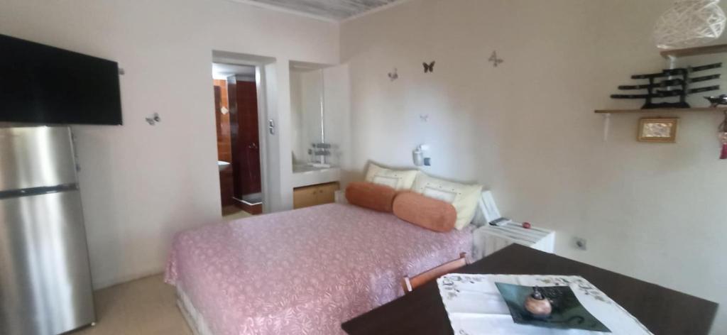 a small room with a bed and a table in it at 1st floor studio in Kalathas in Kalathas