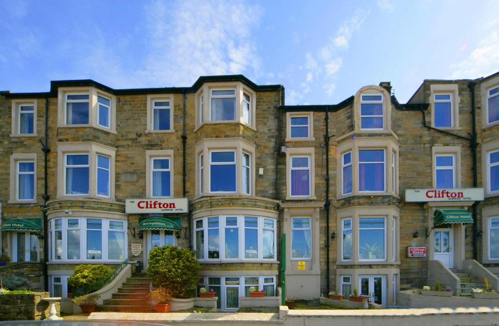 a large brick building with white windows at The Clifton Seafront Hotel in Morecambe