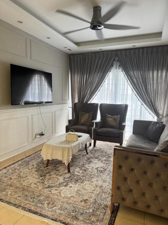 a living room with two couches and a tv at Puchong Permata Homestay 3BR in Puchong
