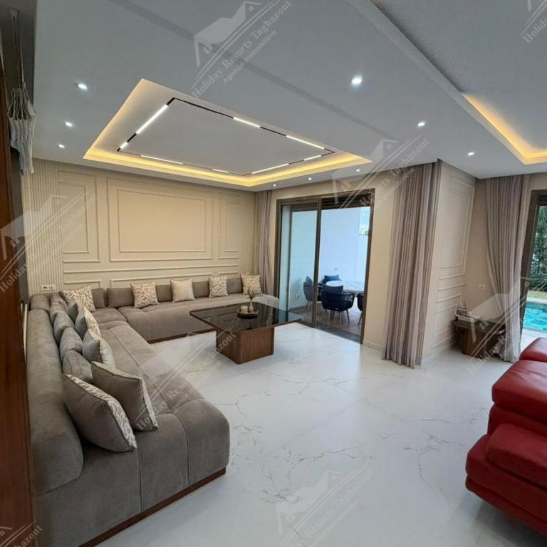 a living room with a couch and a table at Serenity Sea Villa Taghazout Bay Amda in Taghazout