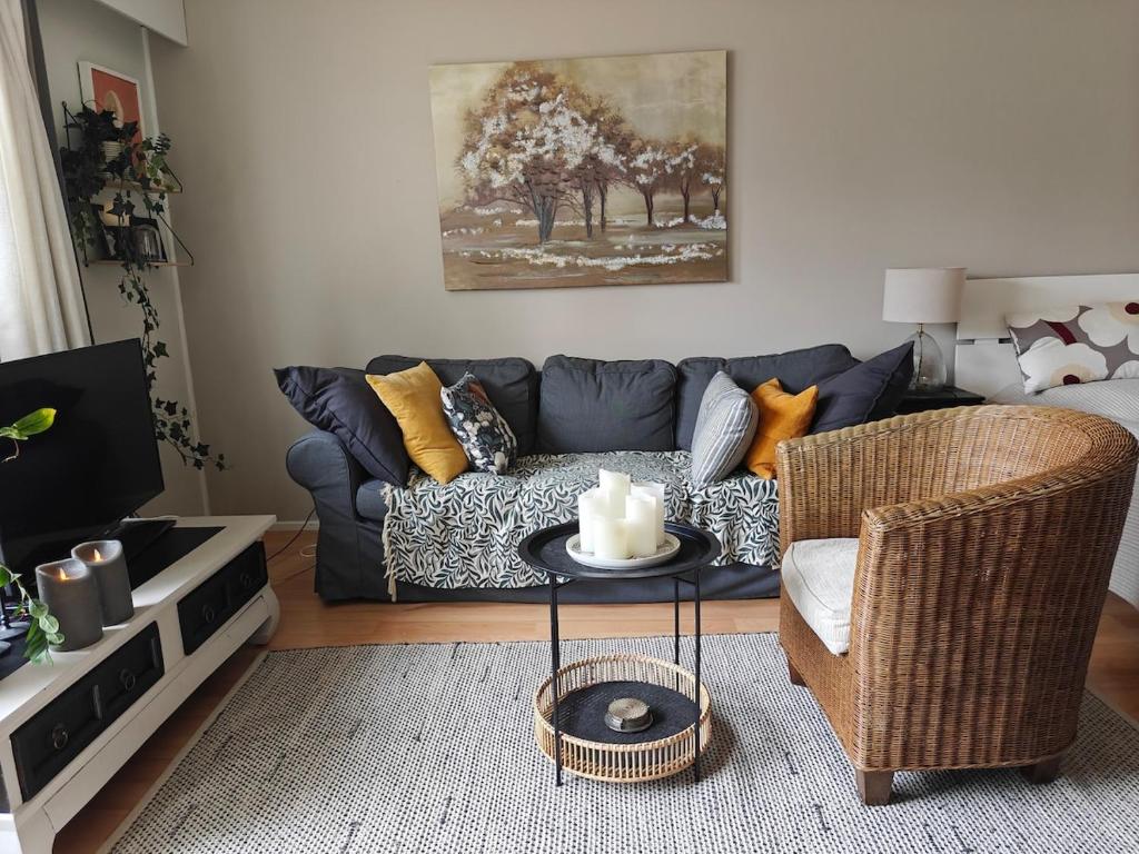a living room with a blue couch and a table at Luhtitalo two-room apartment in Rovaniemi