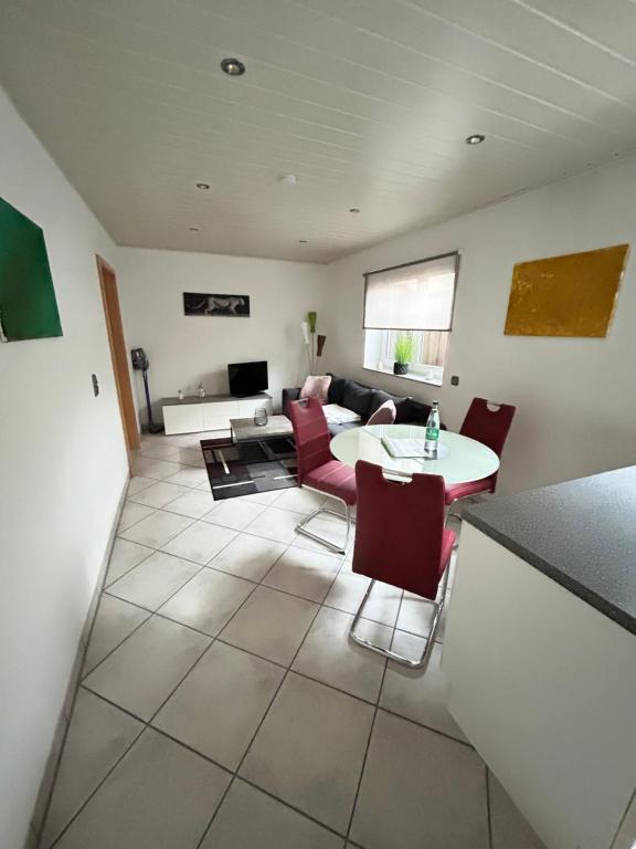 a living room with a table and a couch at Wohnung Ahorn in Riedstadt