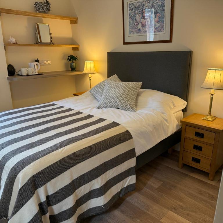 a bedroom with a bed with a black and white striped blanket at Town Centre - 22 Billet Street in Taunton