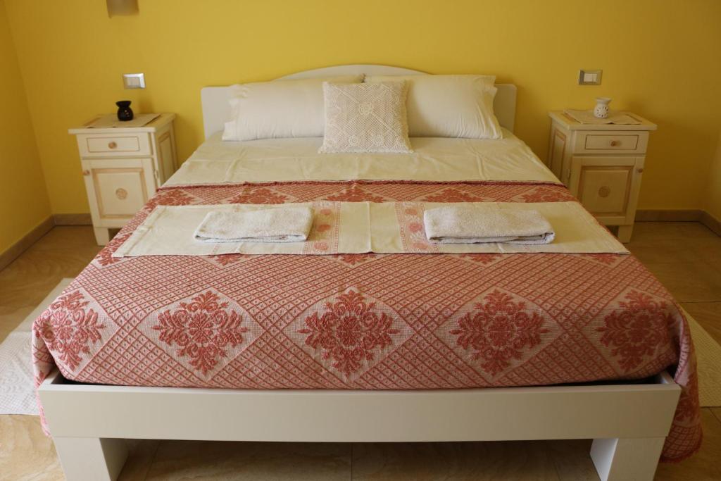 a bedroom with a bed with two night stands at Sardinia for you in Oristano