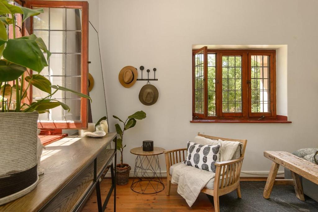 a room with a table and a chair and a window at Am Flus- at the river in Stellenbosch