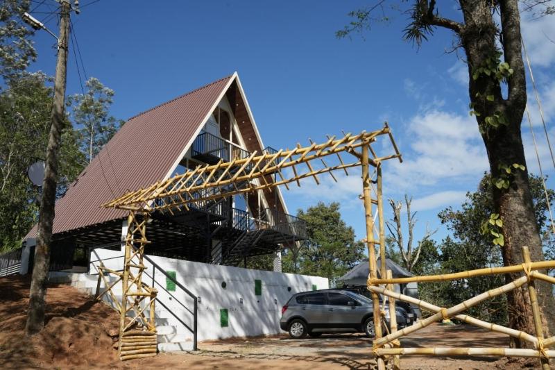 a house with a car parked in front of it at Idukki Nook in Idukki