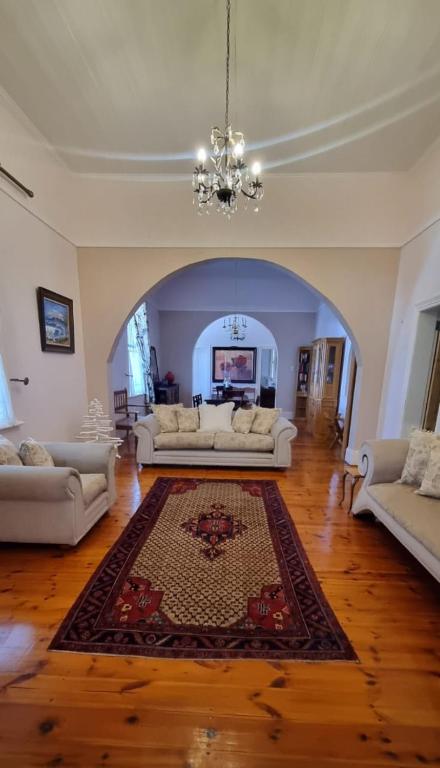 a living room with two couches and a rug at 14th on West in Graaff-Reinet