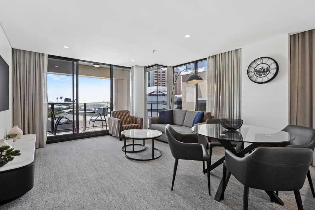 a living room with a couch and a table at Urban Oasis City 2 Bed Apartment Oaks Horizons in Adelaide