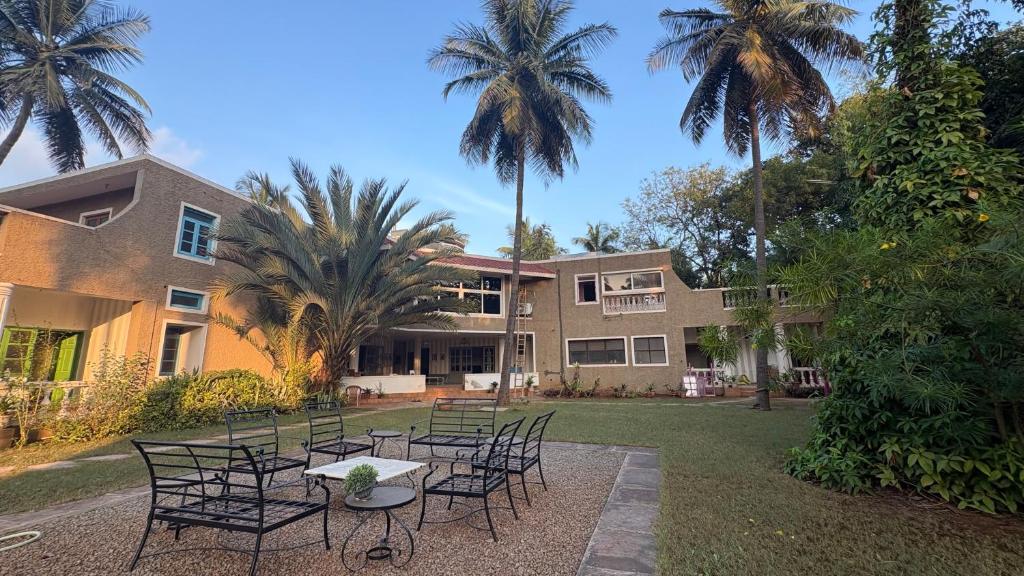 a table and chairs in front of a building at Seclude Hampi 1800 in Sandūr