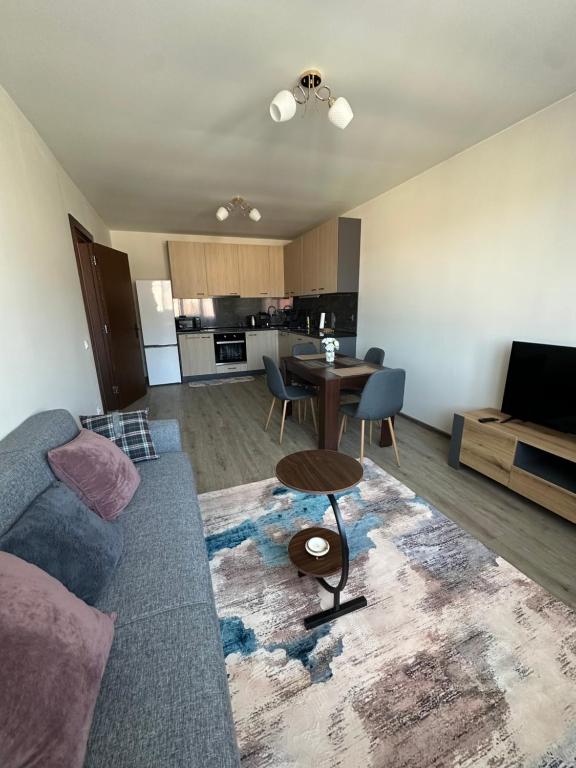 a living room with a couch and a table at Tryavna Central Apartments-Harmony in Tryavna