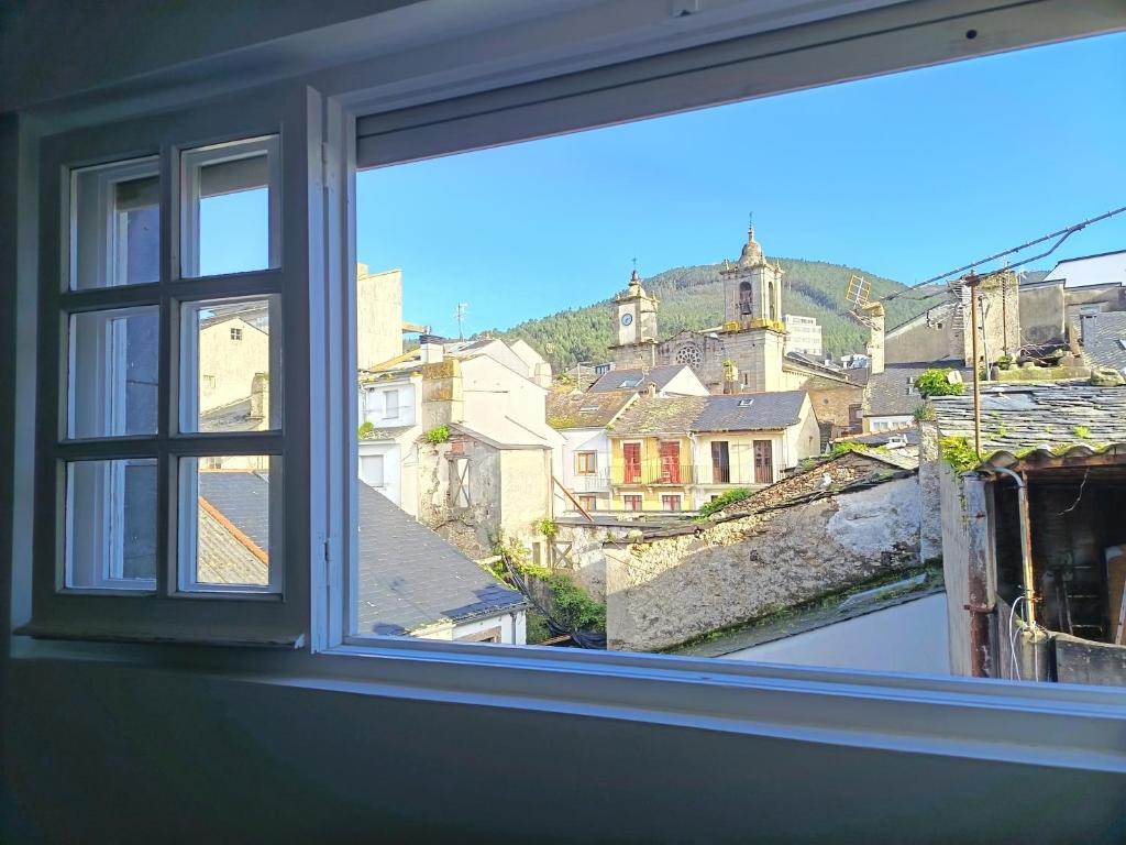 an open window with a view of a city at Apartamento Maruja Mallo in Viveiro
